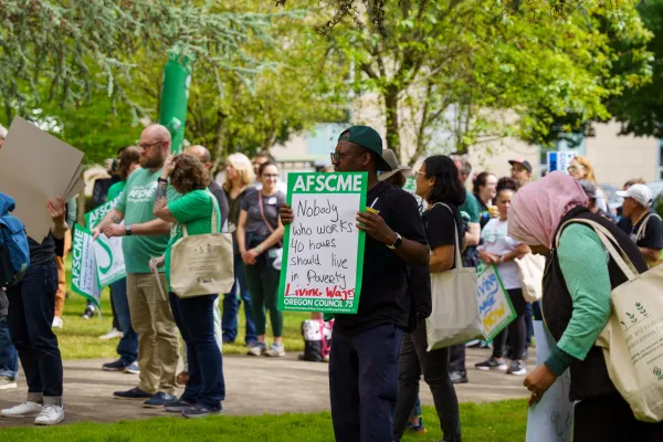 Oregon AFSCME Local 328 member holding a sign