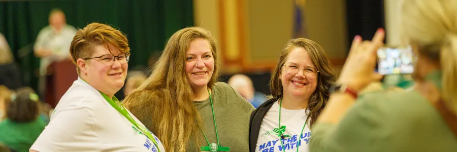 Group of people posed and smiling for a camera