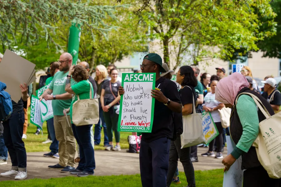 Oregon AFSCME Local 328 member holding a sign
